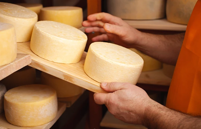 Photo of a cheese board with cheese on it